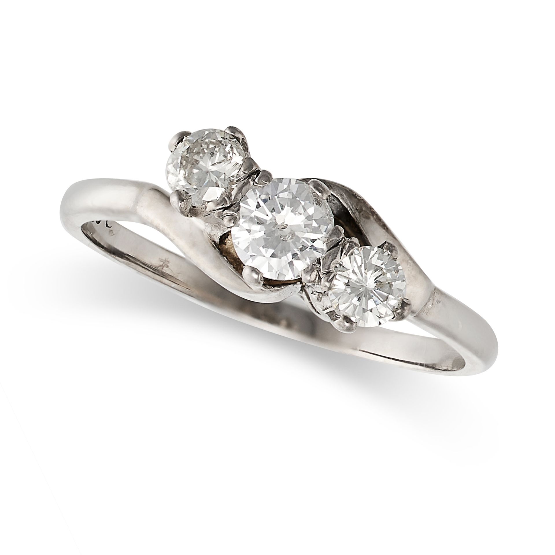 A DIAMOND THREE STONE RING in white gold, set with three round brilliant cut diamonds in a crosso...