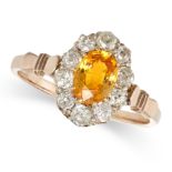 A VINTAGE YELLOW SAPPHIRE AND DIAMOND CLUSTER RING in yellow gold, set with an oval cut yellow sa...