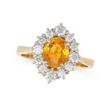 A YELLOW SAPPHIRE AND DIAMOND CLUSTER RING in 18ct yellow gold, set with an oval cut yellow sapph...
