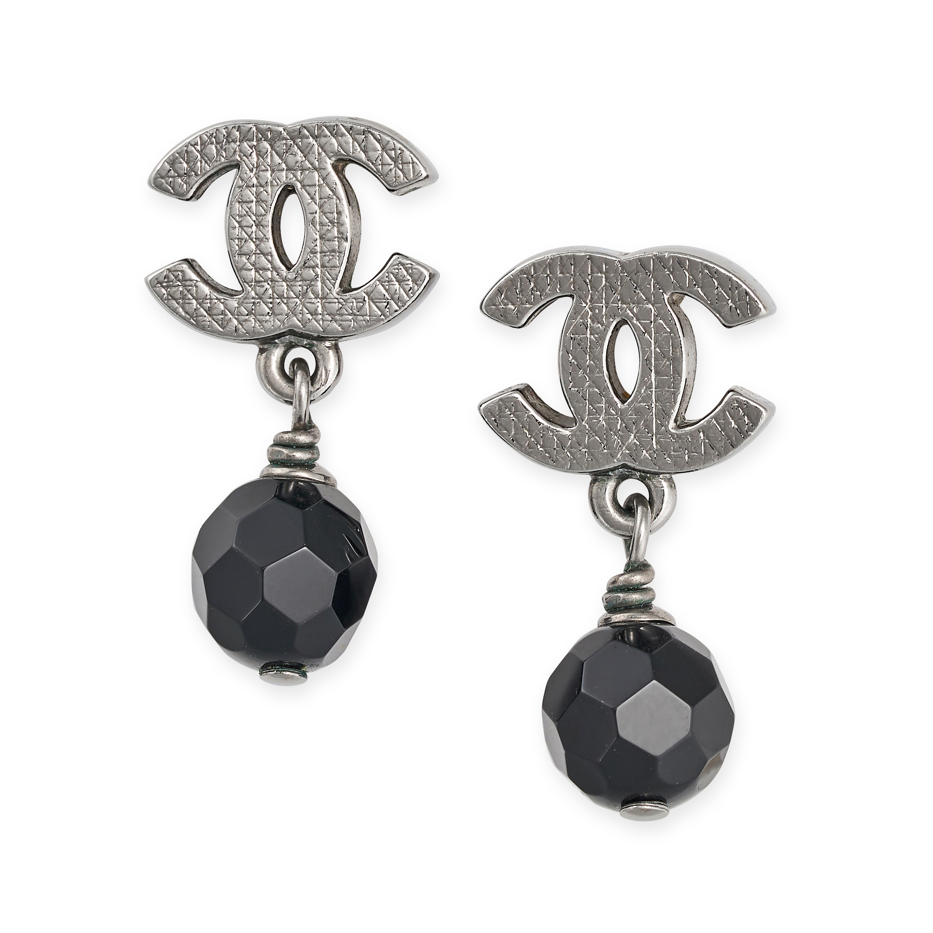 CHANEL, A PAIR OF BLACK BEAD CC EARRINGS in a geometric design, the black bead hanging from a tex...