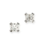 A PAIR OF DIAMOND STUD EARRINGS in platinum, each set with a French cut diamond, both diamonds to...