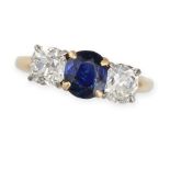 A SAPPHIRE AND DIAMOND THREE STONE RING in 14ct yellow gold, set with an oval cut sapphire accent...