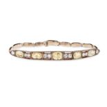 AN ANTIQUE YELLOW SAPPHIRE AND WHITE SAPPHIRE BRACELET in yellow gold, designed as a hinged panel...
