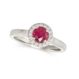A RUBY AND DIAMOND CLUSTER RING in platinum, set with a round cut ruby of 0.70 carats in a border...