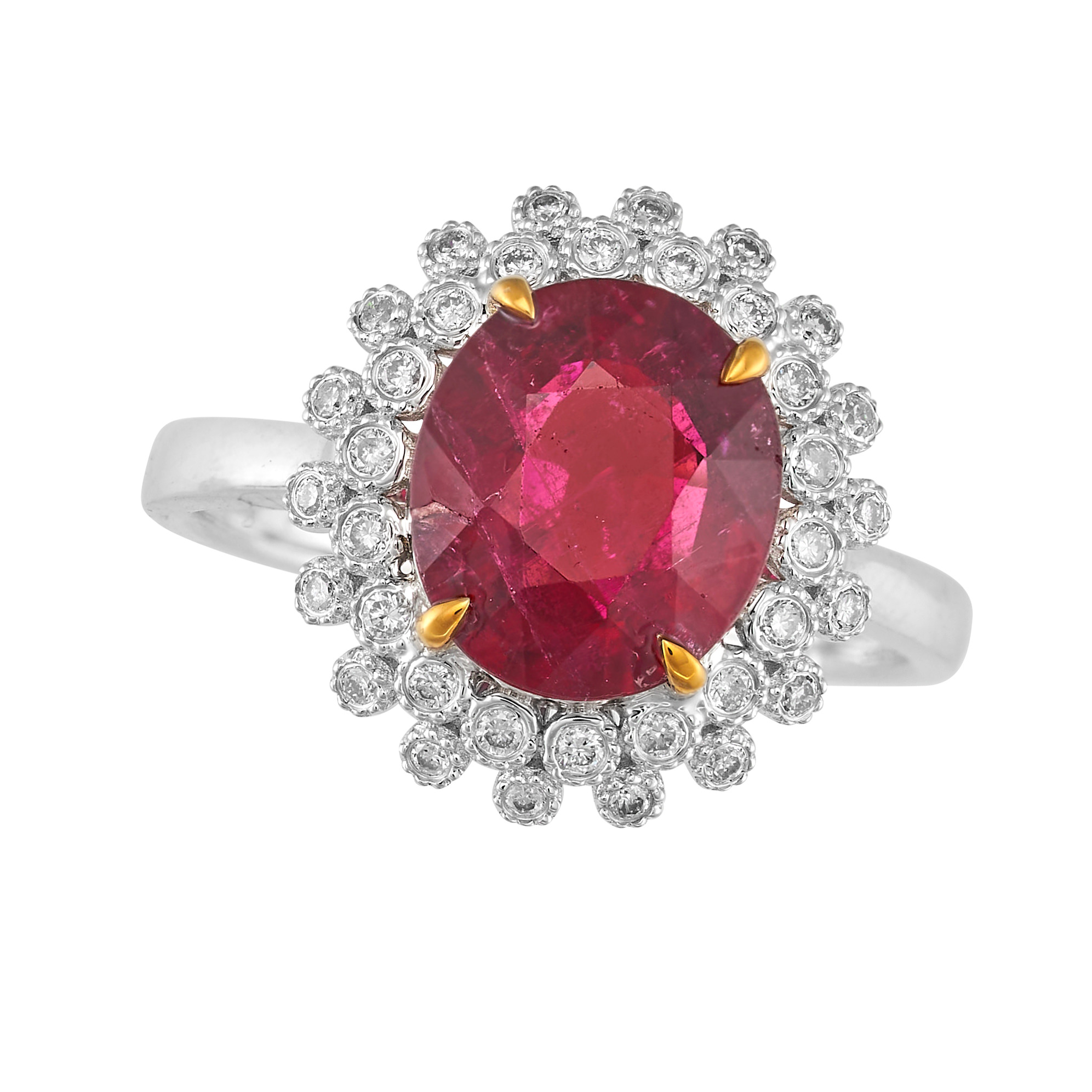 A RUBELLITE TOURMALINE AND DIAMOND CLUSTER RING in 18ct white gold, set with an oval cut rubellit...