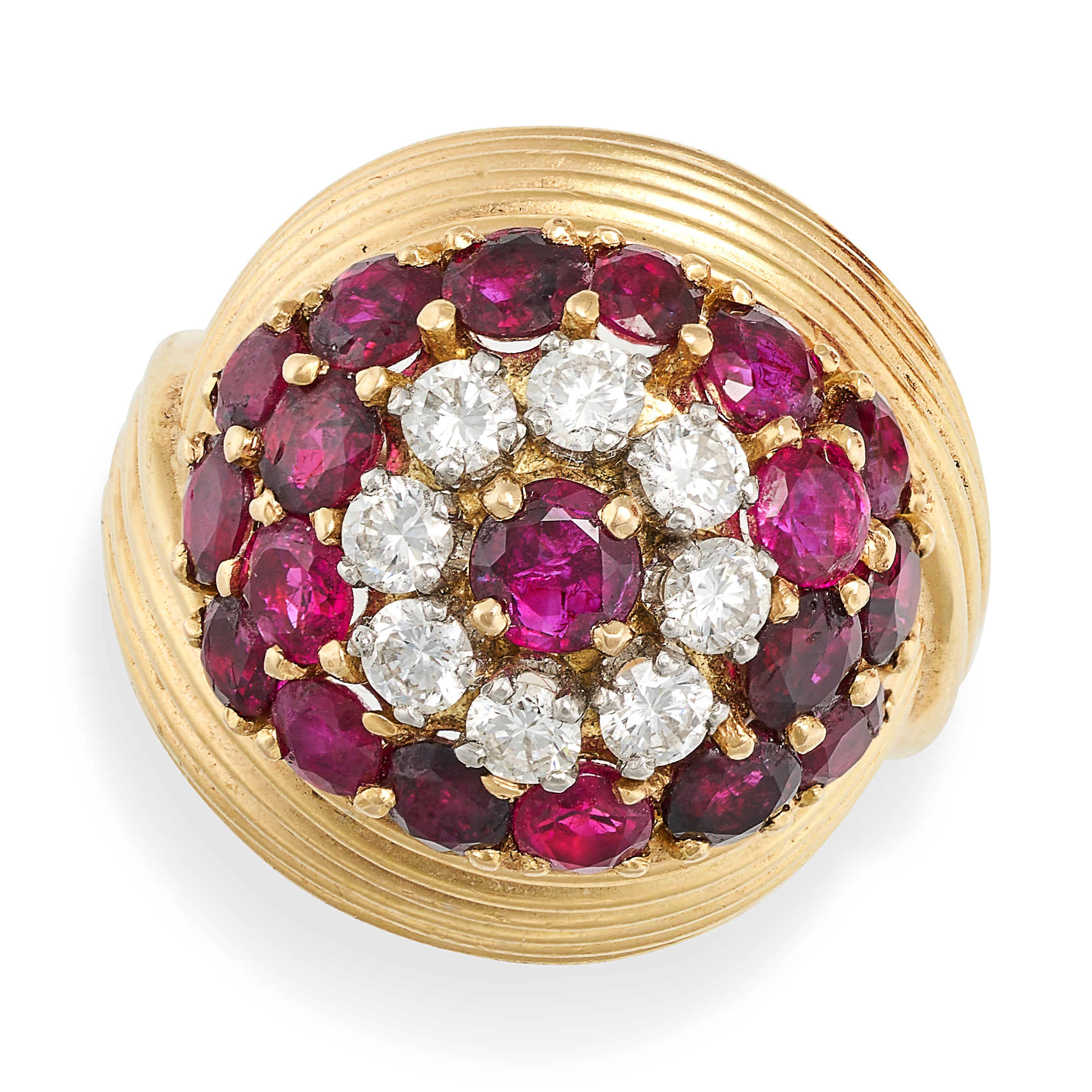 A VINTAGE RUBY AND DIAMOND BOMBE RING in yellow gold, set to the centre with round cut ruby in a ...
