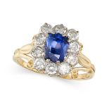 A VINTAGE SAPPHIRE AND DIAMOND CLUSTER RING in 18ct yellow gold, set with a cushion cut sapphire ...