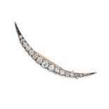 AN ANTIQUE VICTORIAN DIAMOND CRESCENT MOON BROOCH in yellow gold and silver, set with a row of gr...