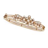 AN ANTIQUE VICTORIAN PEARL BANGLE in yellow gold, the openwork hinged bangle set with pearls in a...