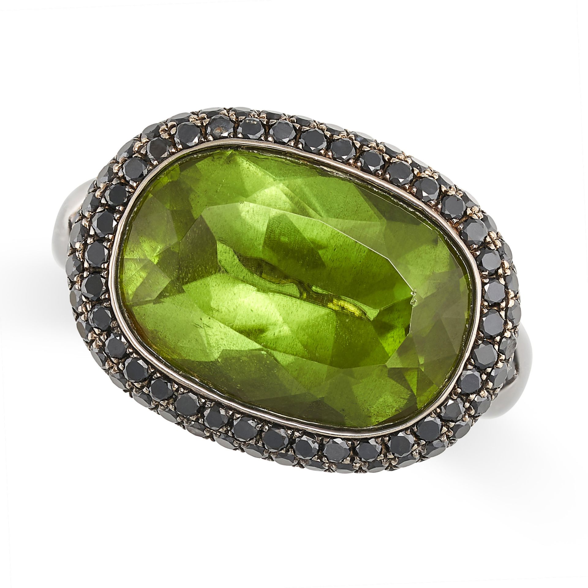 A PERIDOT AND BLACK DIAMOND COCKTAIL RING in 18ct blacked gold, set with an oval cut peridot of a...