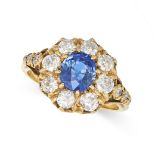 A SAPPHIRE AND DIAMOND CLUSTER RING in 18ct yellow gold, set with an oval cut sapphire of approxi...