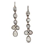 A PAIR OF ANTIQUE DIAMOND DROP EARRINGS the articulated bodies each set with a row of old cut dia...