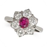 A VINTAGE RUBY AND DIAMOND CLUSTER RING in 18ct white gold, set with an oval cut ruby in a cluste...