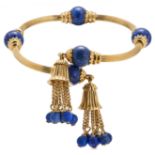 A FINE ANTIQUE LAPIS LAZULI BANGLE in 18ct yellow gold, the openwork bangle set with polished lap...