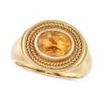 A VINTAGE CITRINE DRESS RING in 18ct yellow gold, set with an oval cut citrine accented by braide...