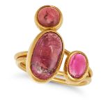 A PINK TOURMALINE DRESS RING in yellow gold, set with three cabochon pink tourmalines on a bifurc...