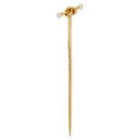 A PEARL LOVERS KNOT STICK PIN in yellow gold, designed as a lover's knot motif set with two pearl...