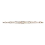 AN ANTIQUE DIAMOND BAR BROOCH, EARLY 20TH CENTURY in yellow gold and platinum, the elongated bar ...