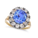 A BURMA NO HEAT SAPPHIRE AND DIAMOND CLUSTER RING in yellow gold and silver, set with a cushion c...