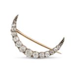 AN ANTIQUE VICTORIAN DIAMOND CRESCENT MOON BROOCH in yellow gold and silver, designed as a cresce...