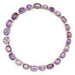 AN ANTIQUE AMETHYST RIVIERE NECKLACE in 15ct yellow gold, set with a row of oval cut amethysts, s...