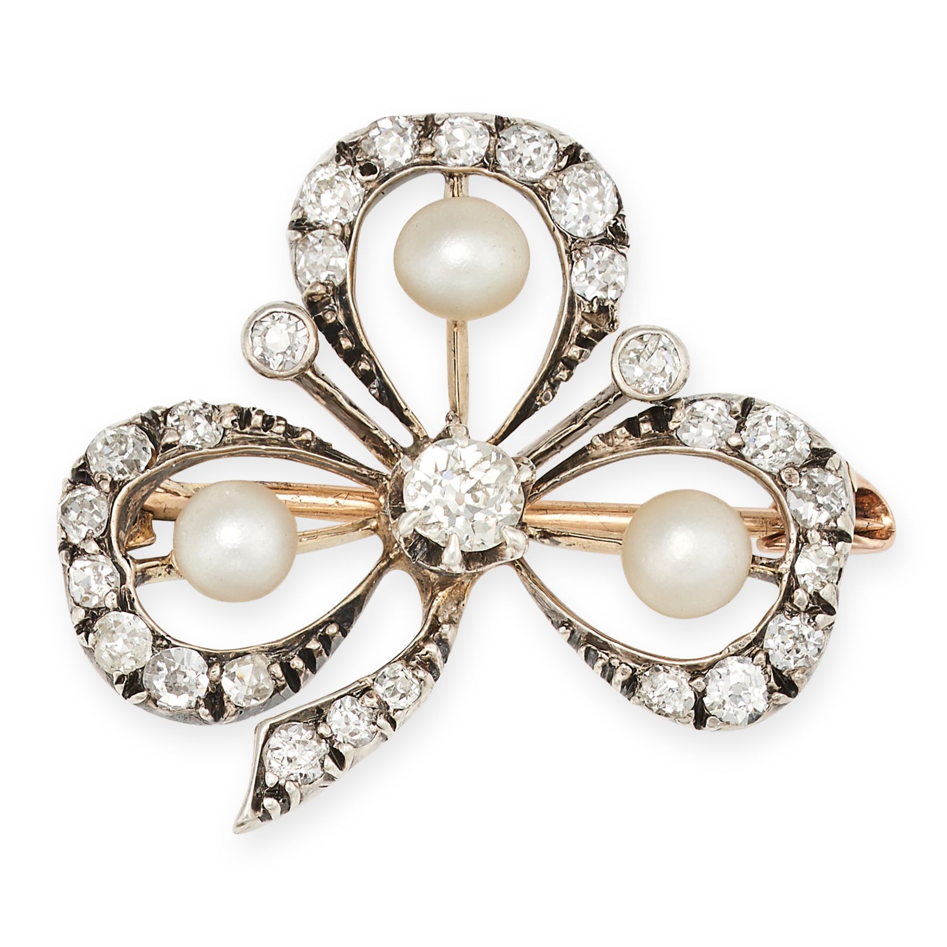 AN ANTIQUE DIAMOND AND PEARL CLOVER BROOCH in yellow gold and silver, designed as a three leaf cl...