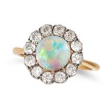 AN ANTIQUE OPAL AND DIAMOND CLUSTER RING in yellow gold and silver, set with a round cabochon opa...