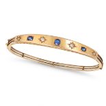 AN ANTIQUE VICTORIAN SAPPHIRE AND DIAMOND BANGLE in 15ct yellow gold, set with a row of alternati...