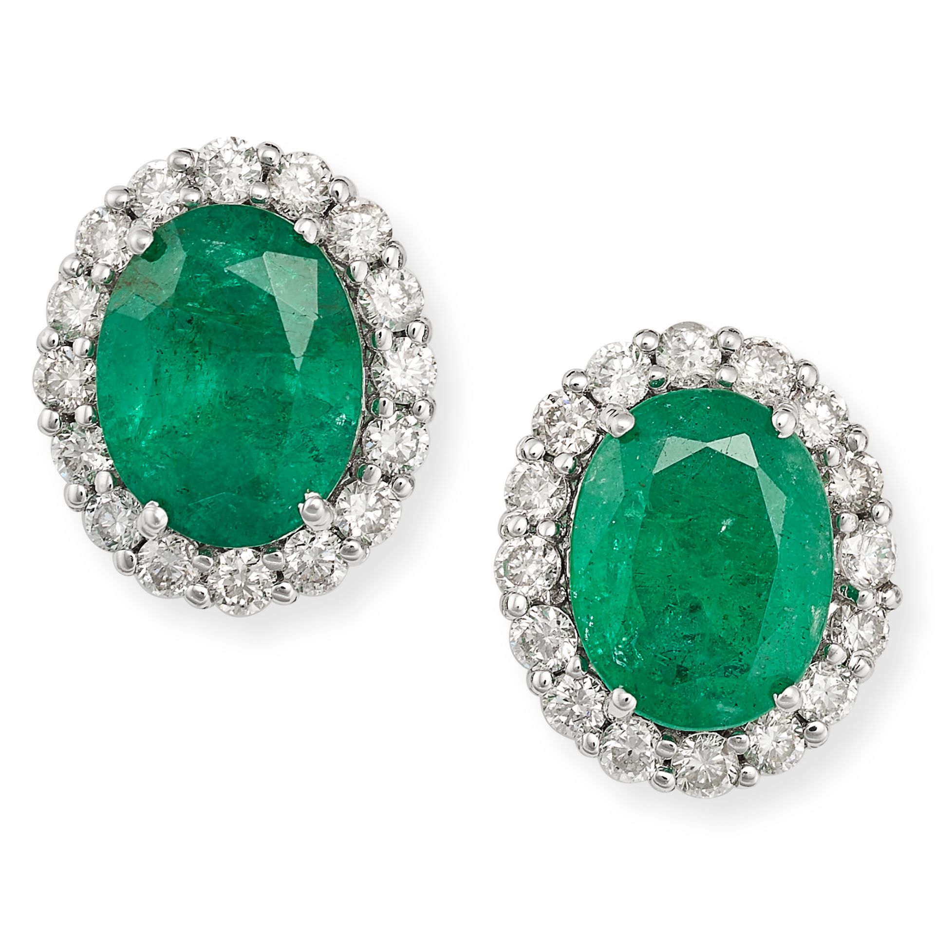 A PAIR OF EMERALD AND DIAMOND CLUSTER STUD EARRINGS in 18ct white gold, each set with an oval cut...