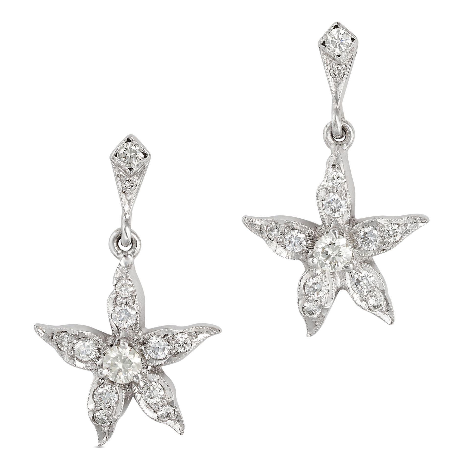 A PAIR OF DIAMOND FLOWER DROP EARRINGS in white gold, each comprising two round cut diamonds susp...