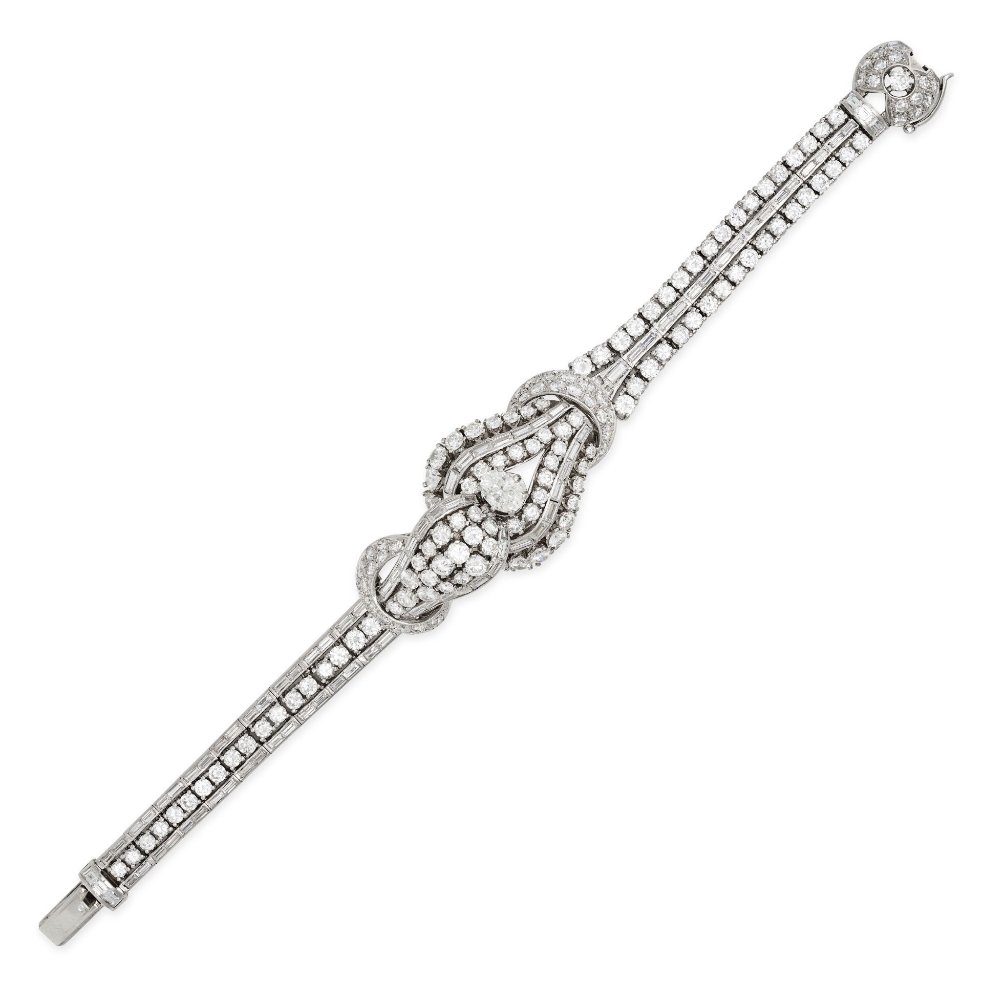 A VINTAGE DIAMOND BRACELET in platinum, set to the centre with an oval cut diamond of approximate...