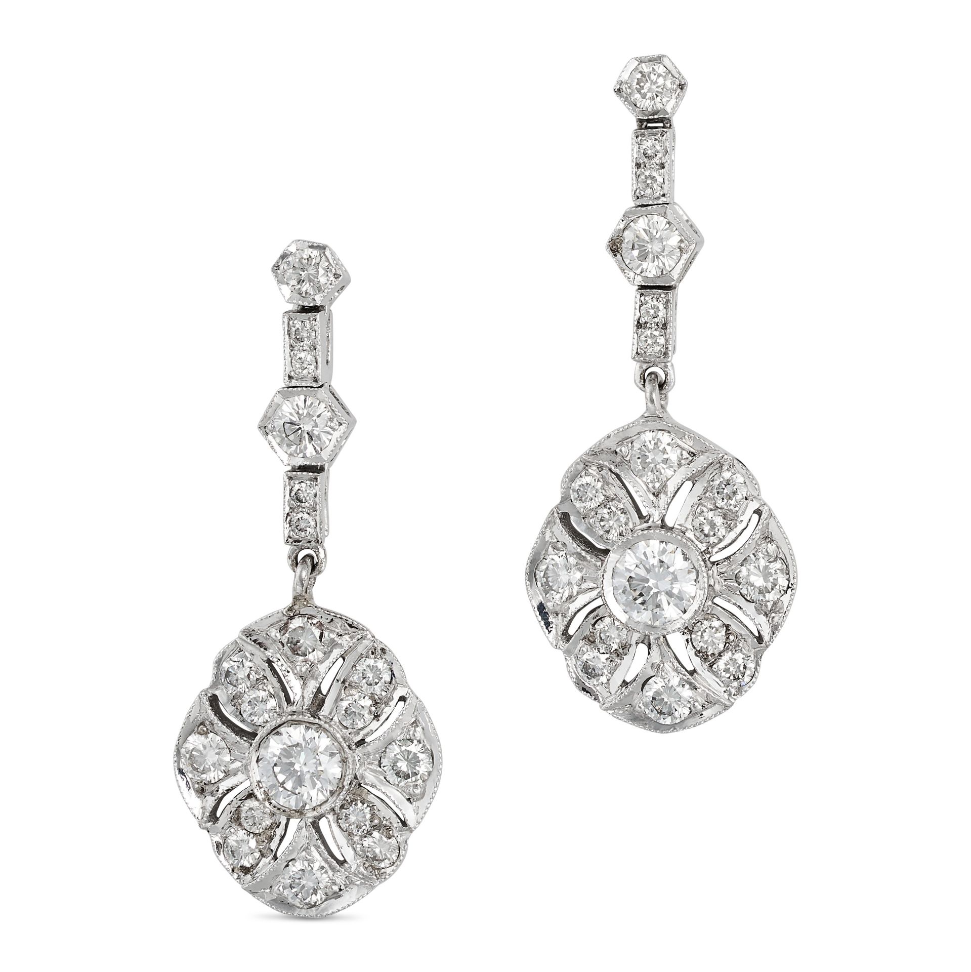 A PAIR OF DIAMOND DROP EARRINGS in 18ct white gold, comprising a row of round brilliant cut diamo...