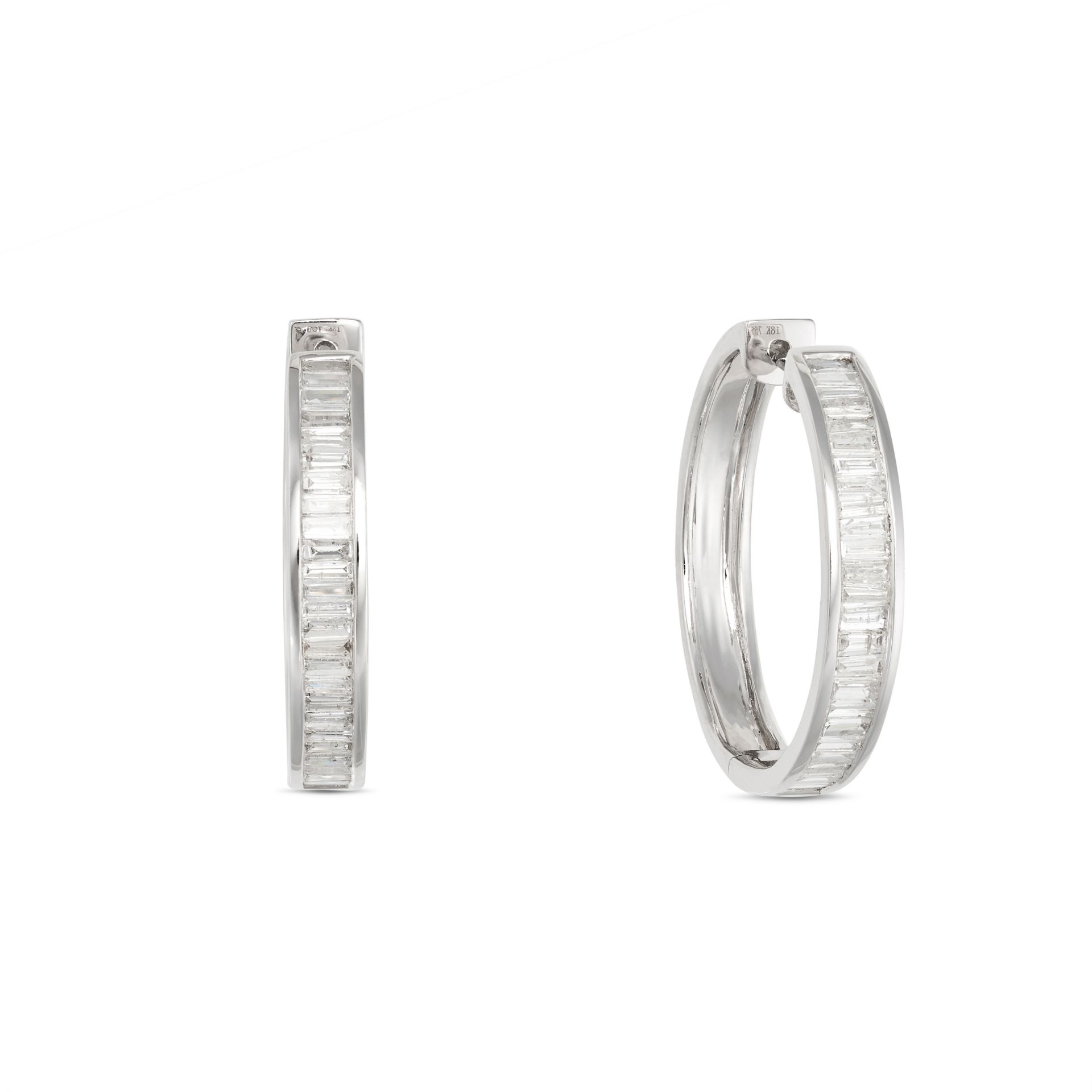 A PAIR OF DIAMOND HOOP EARRINGS in 18ct white gold, designed as a hoop set with a row of baguette...