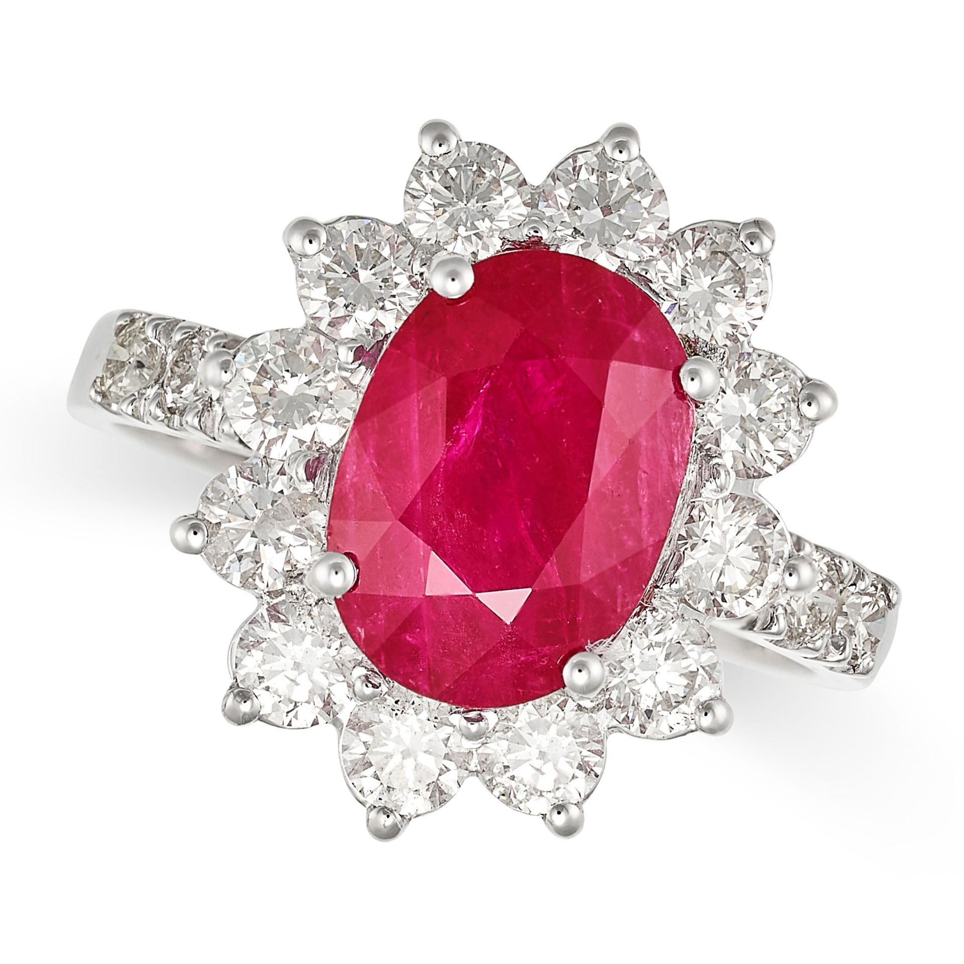 A RUBY AND DIAMOND CLUSTER RING in white gold, set with an oval cut ruby of 3.08 carats in a clus...