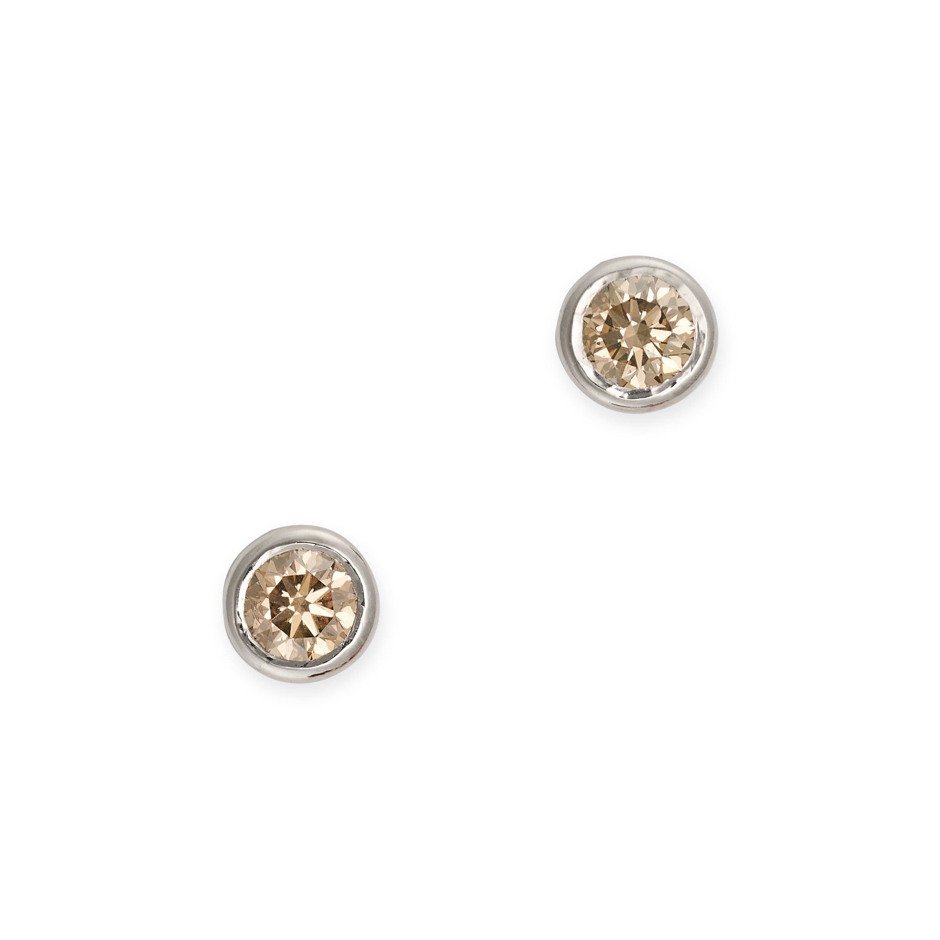 A PAIR OF FANCY BROWN DIAMOND STUD EARRINGS in platinum, each set with a round brilliant cut fanc...