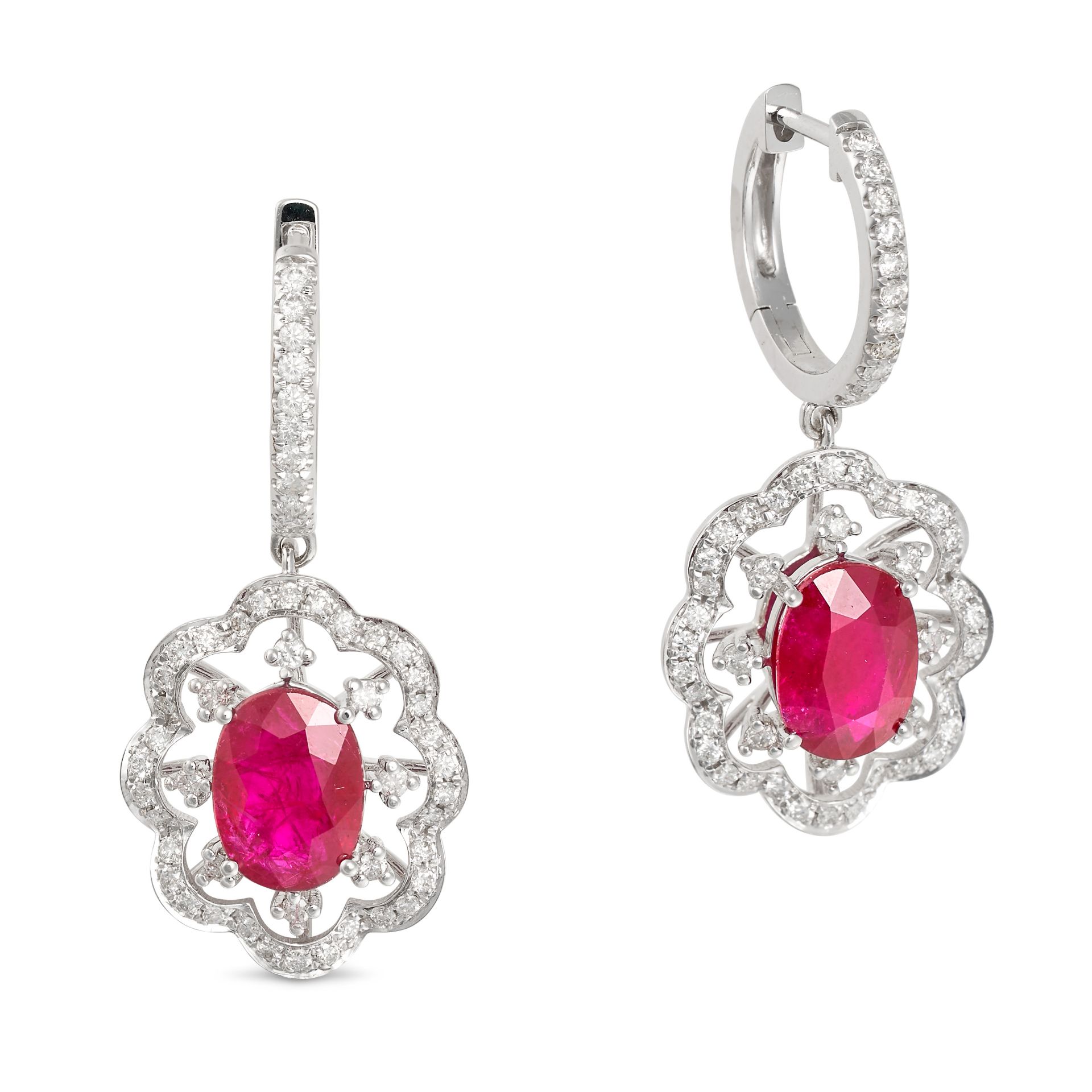 A PAIR OF RUBY AND DIAMOND DROP EARRINGS in 18ct white gold, comprising a hoop set with a row of ...