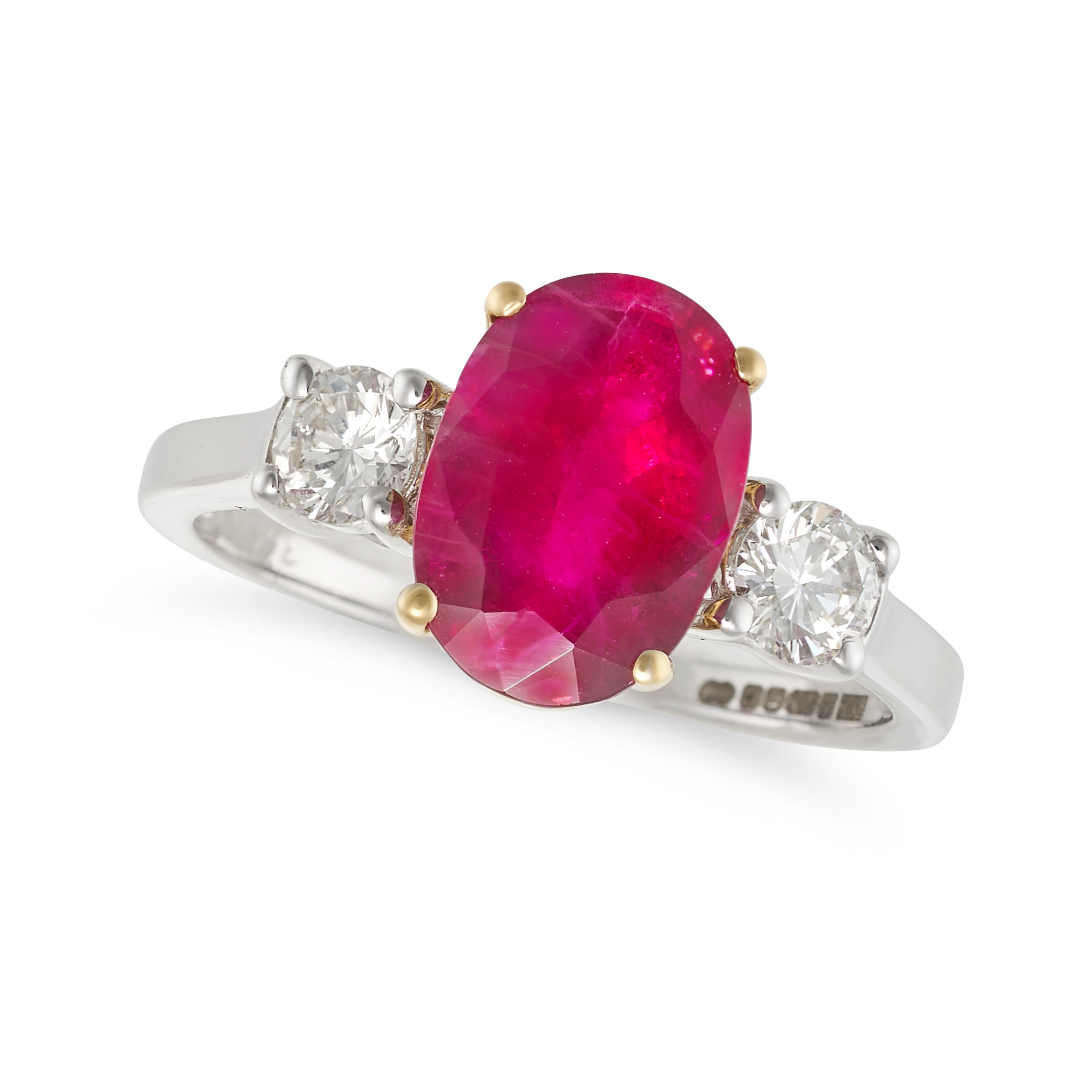 A RUBY AND DIAMOND THREE STONE RING in 18ct white gold, set with an oval cut ruby of approximatel...