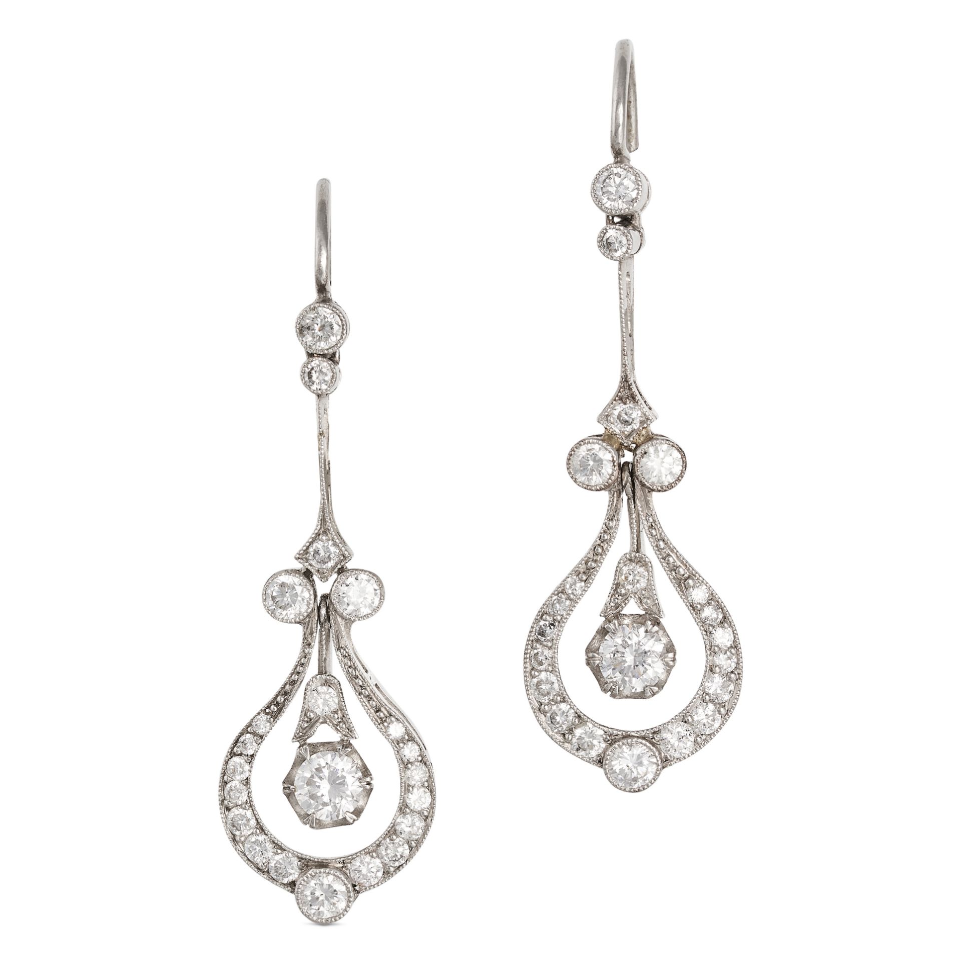 A PAIR OF VINTAGE DIAMOND DROP EARRINGS in an openwork design, suspending a round brilliant cut d...
