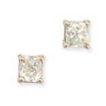 A PAIR OF DIAMOND STUD EARRINGS in 18ct white gold, each set with an old cushion cut diamond of a...