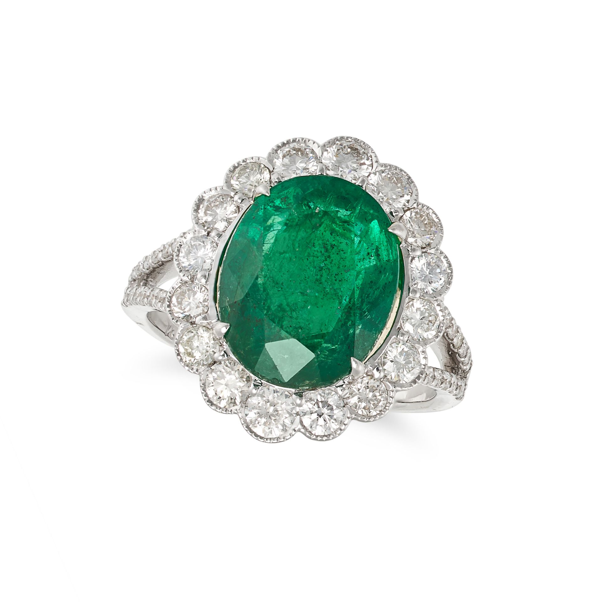 AN EMERALD AND DIAMOND CLUSTER RING in 18ct white gold, set with an oval cut emerald of 5.05 cara...