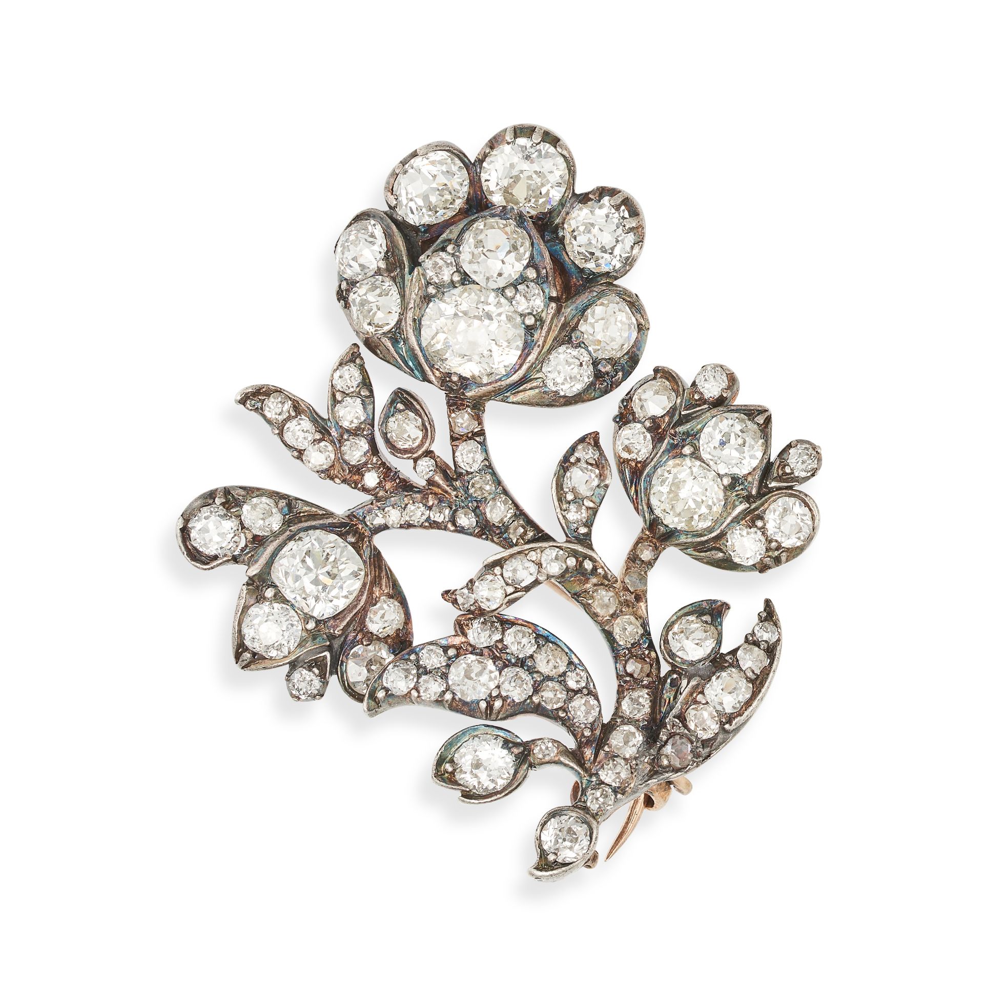 AN ANTIQUE DIAMOND FLOWER BROOCH in yellow gold and silver, designed as a spray of flowers set th...