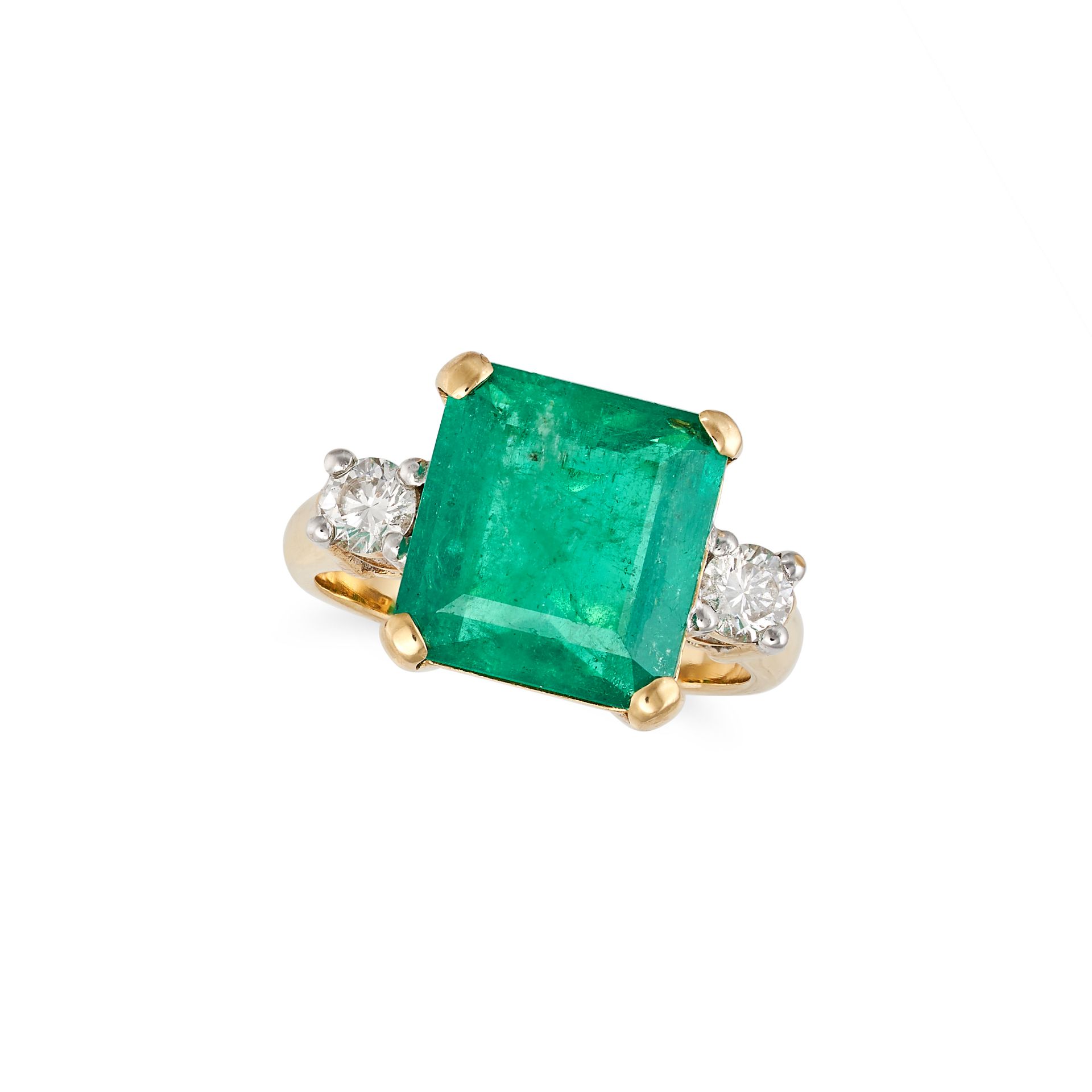 AN EMERALD AND DIAMOND THREE STONE RING in 18ct yellow gold, set with an octagonal step cut emera...