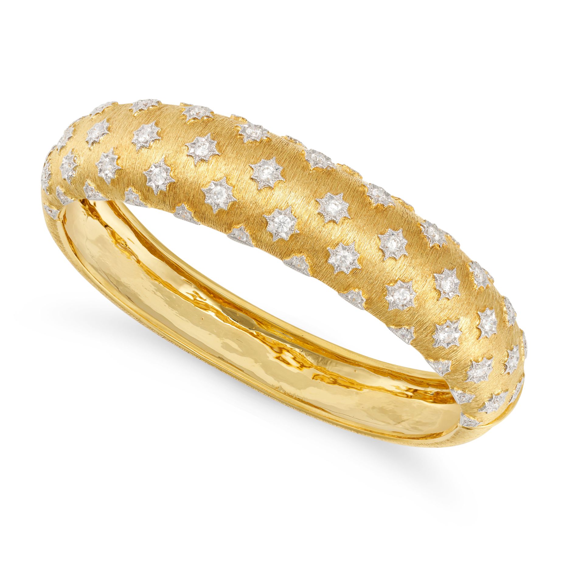 A DIAMOND BANGLE in 18ct white and yellow gold, in the manner of Buccellati, the textured hinged ...