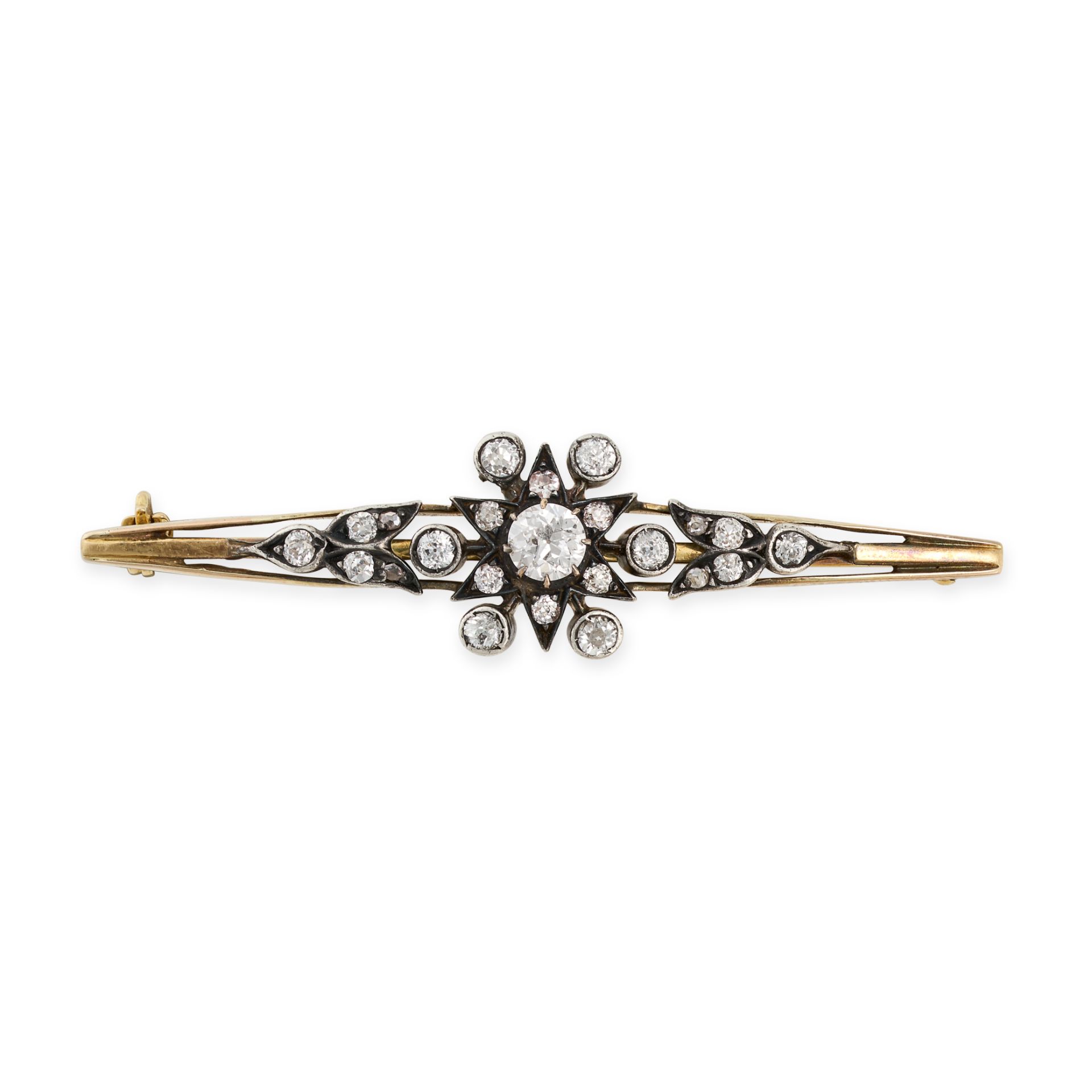 AN ANTIQUE DIAMOND STAR BAR BROOCH in yellow gold and silver, set to the centre with an old cut d...