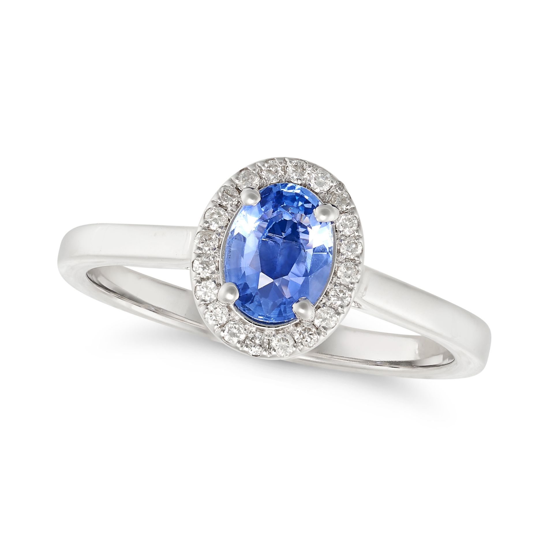 A SAPPHIRE AND DIAMOND CLUSTER RING in 18ct white gold, set with an oval cut sapphire in a cluste...