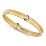 A GOLD BANGLE in 18ct yellow gold, the hinged bangle with one half in an openwork design, stamped...