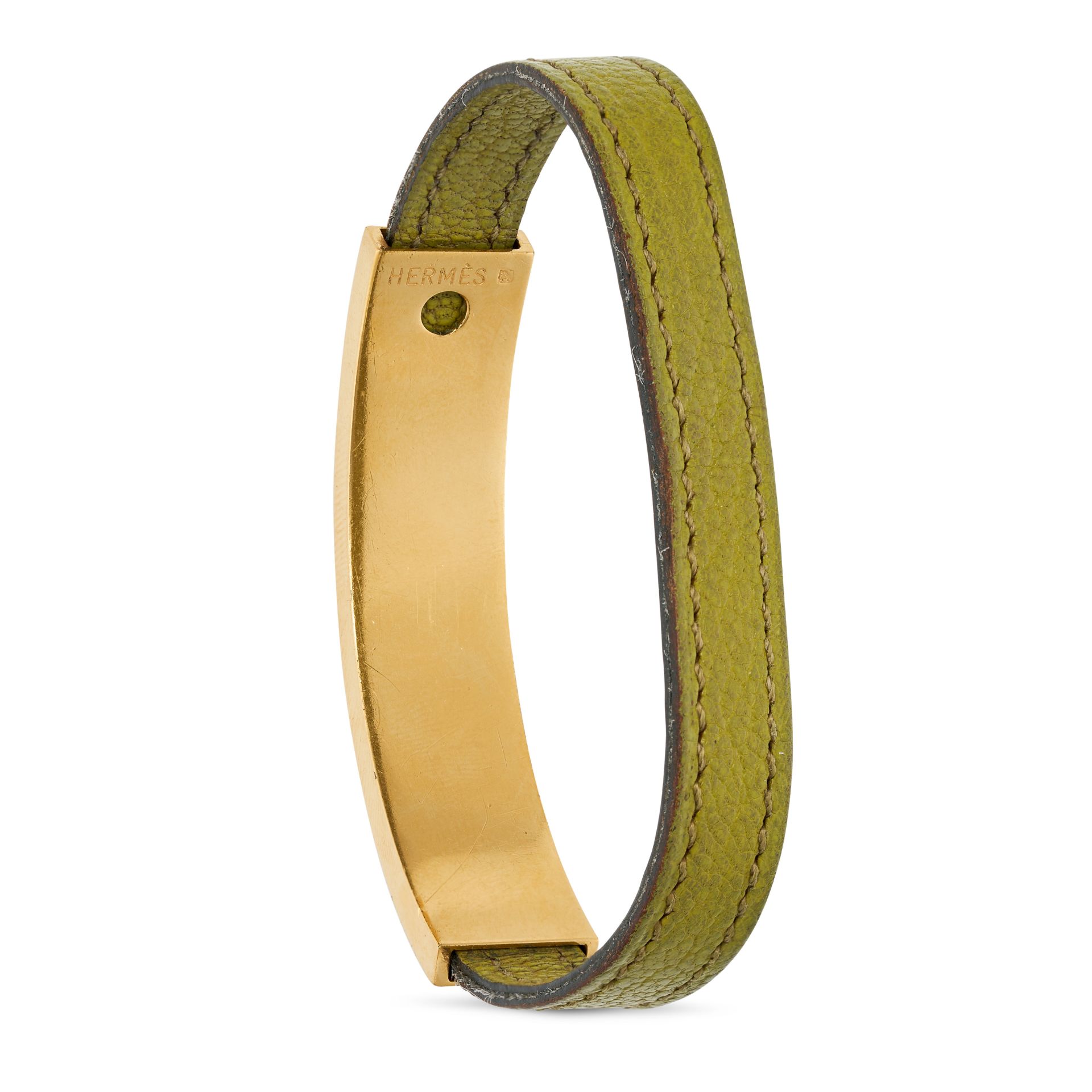 NO RESERVE - HERMES, A SLIDING BRACELET comprising a green leather strap with a sliding bronze pl... - Image 2 of 2