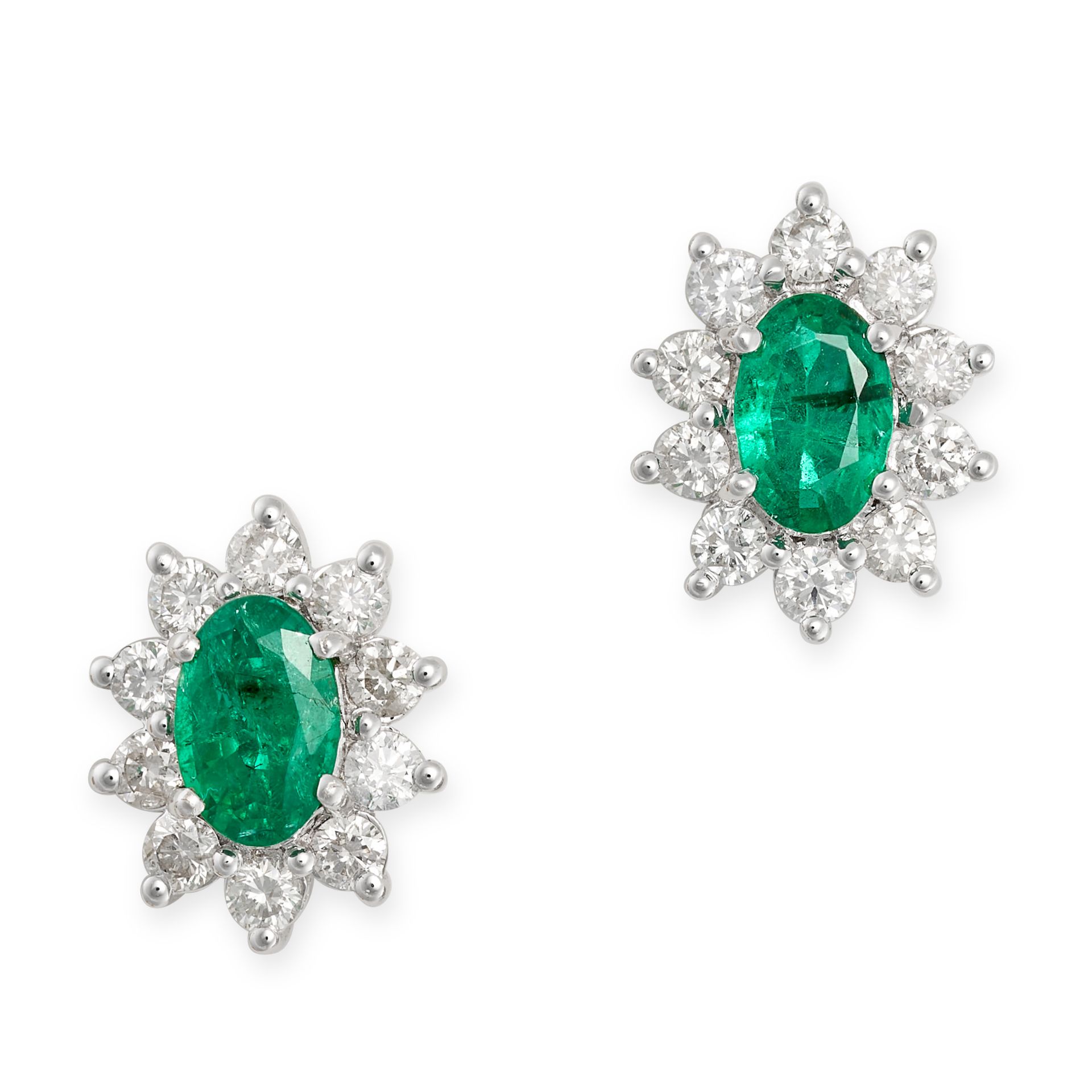 A PAIR OF EMERALD AND DIAMOND CLUSTER EARRINGS in 18ct white gold, each set with an oval cut emer...