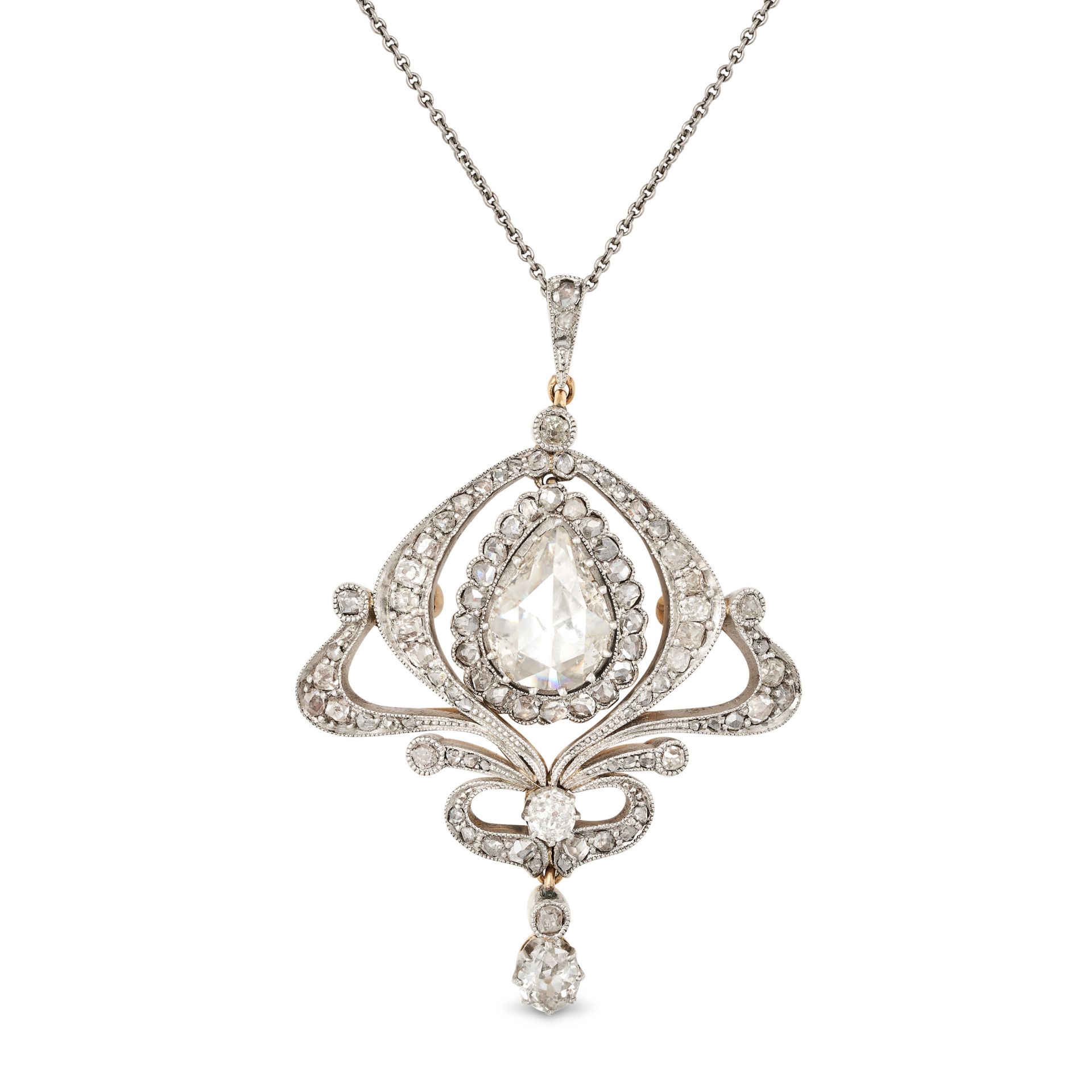 AN ANTIQUE DIAMOND PENDANT NECKLACE in yellow gold and silver, the scrolling openwork pendant set...