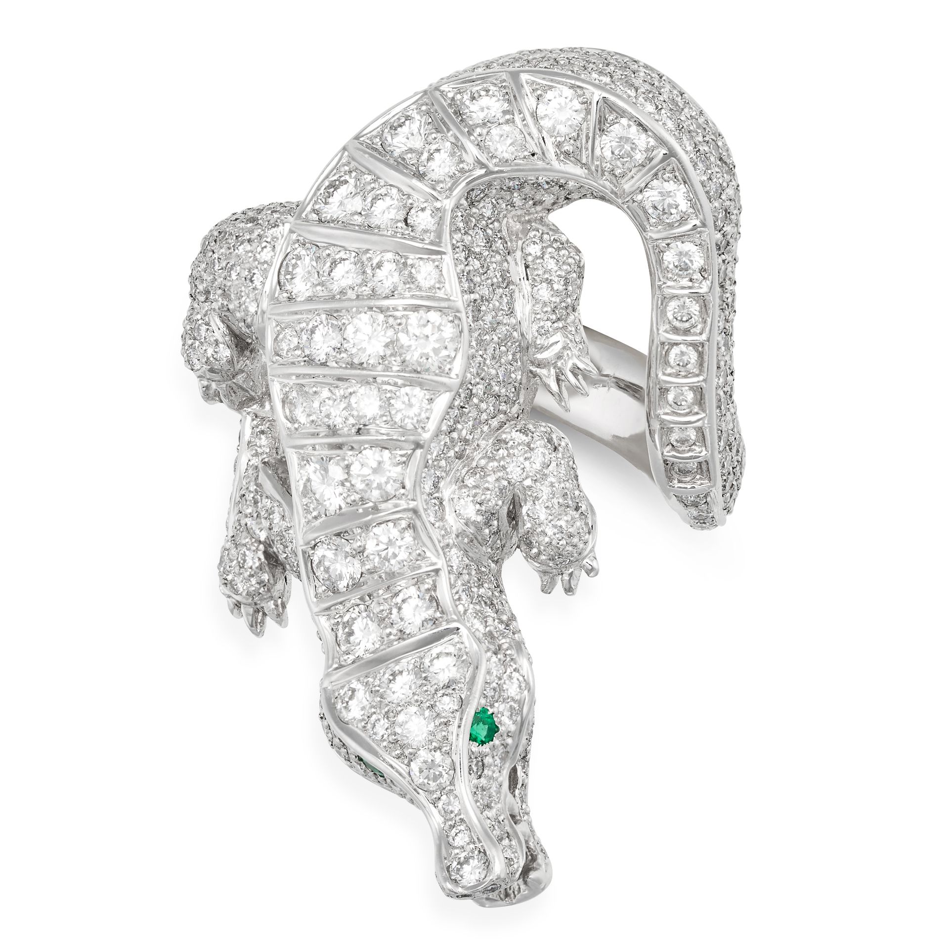 A DIAMOND AND EMERALD CROCODILE RING in platinum, the ring designed as a crocodile set throughout...